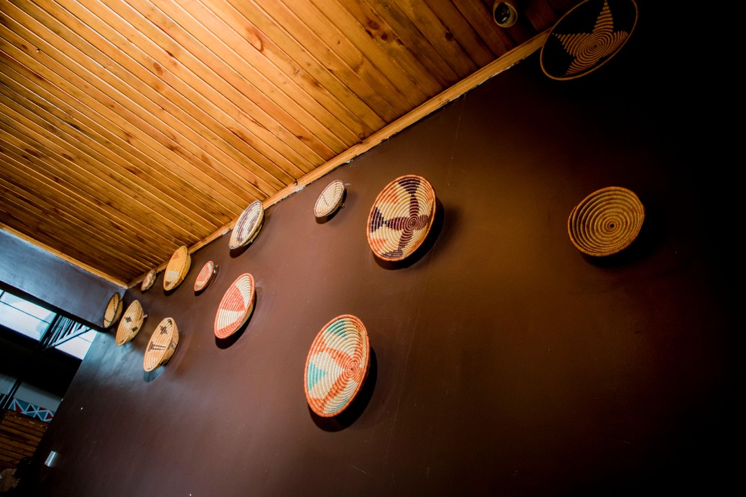 People meeting in a warm cafe setting with drinks on the table.