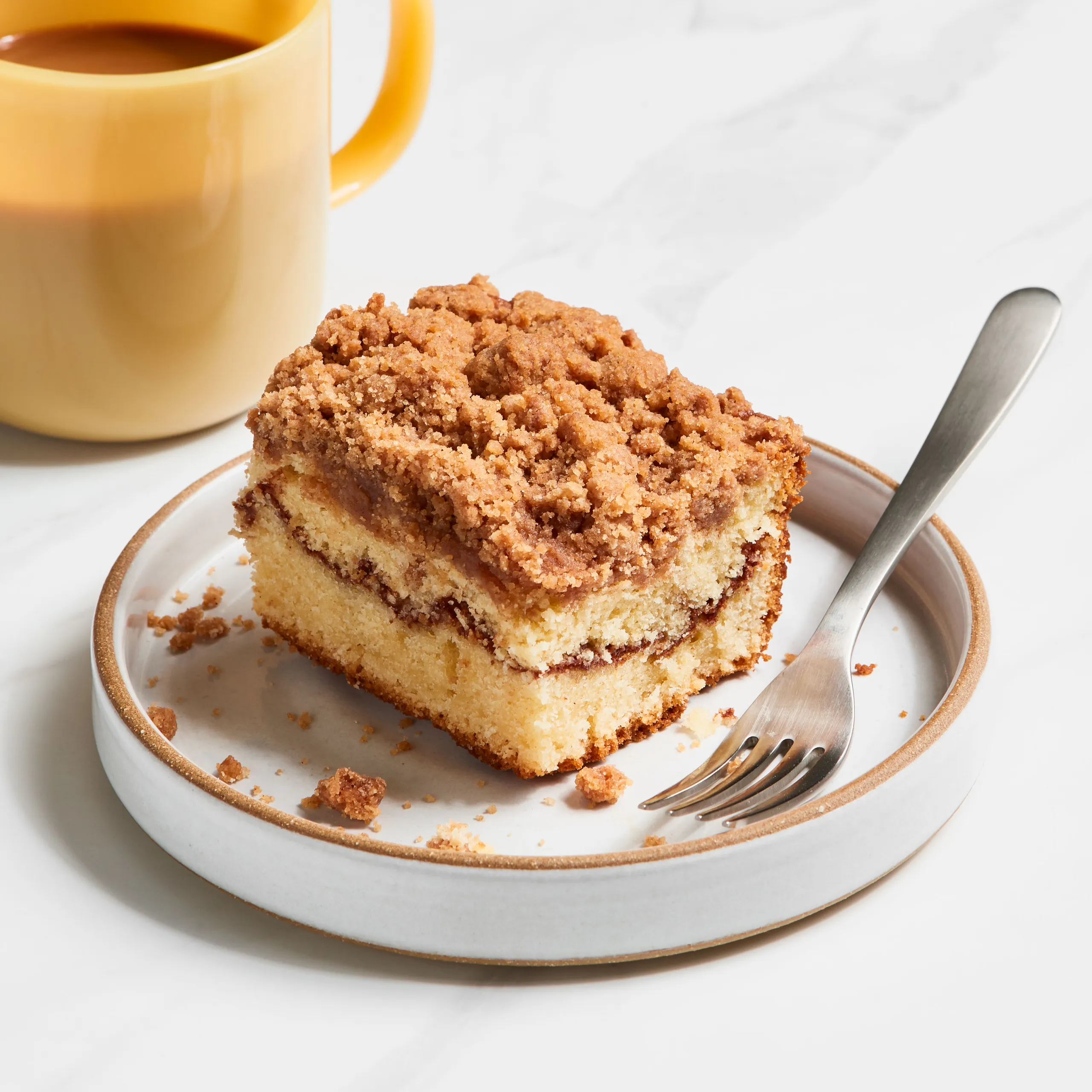 Coffee and pastry pairing in a modern cafe setting.
