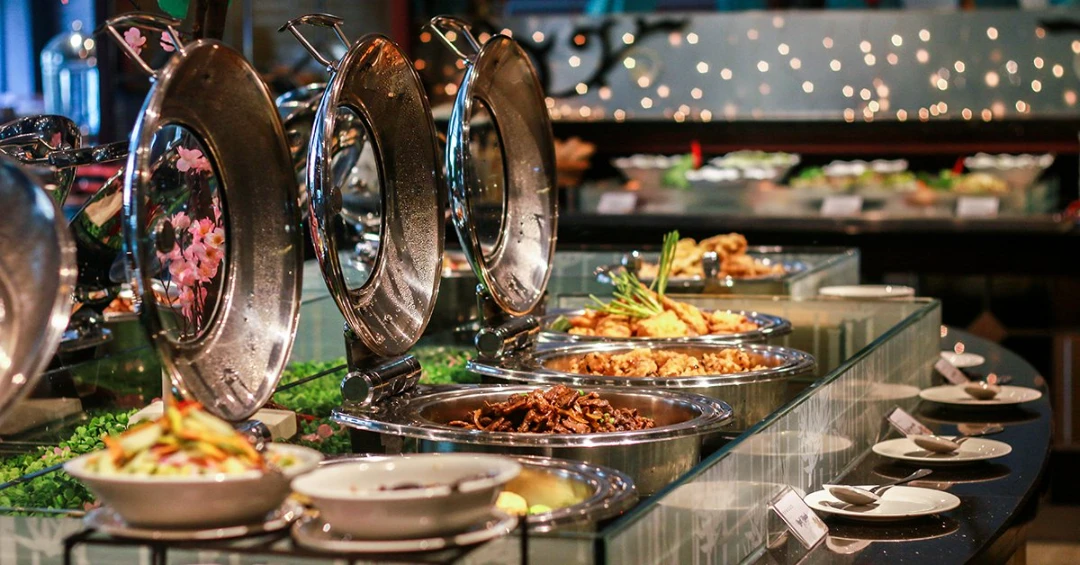 A buffet dining setup with prepared dishes and serving area.